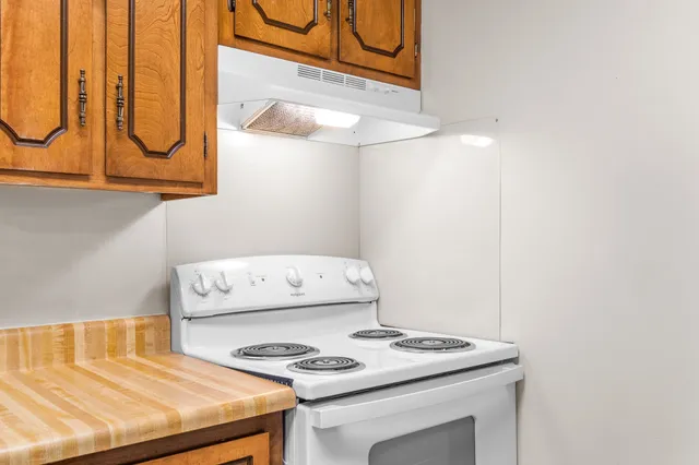 a kitchen with a stove a sink and a microwave