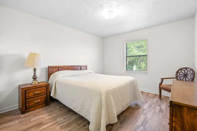 a bedroom with a bed and a lamp on table
