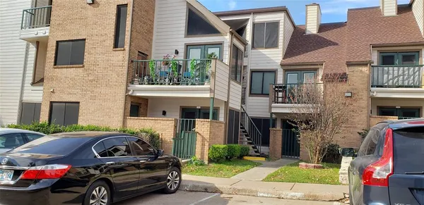 a car parked in front of a brick house