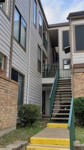 an empty room with wooden floor fan and window