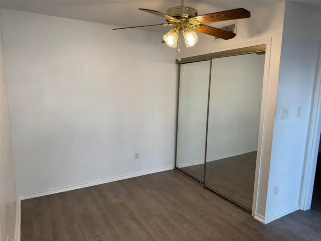 a view of small space with wooden floor and a window