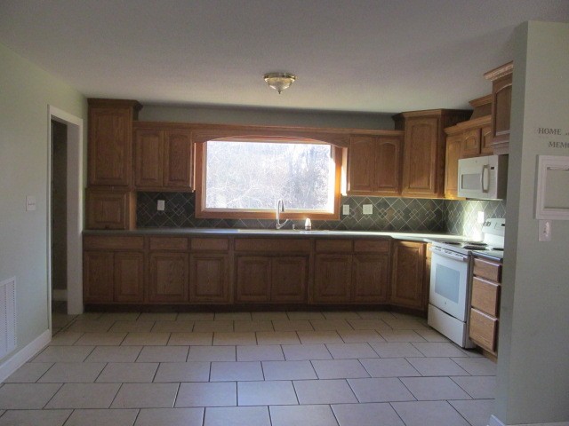 584 Oak Grove Road Goodspring, TN 38460 - Photo 3 of 12 a kitchen with granite countertop a sink a counter top space and appliances