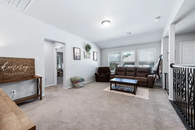 a bedroom with furniture and a air conditioner vent