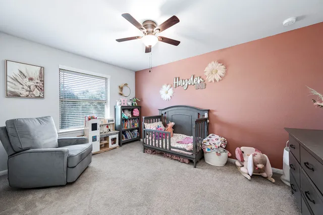 a bedroom with furniture and a large window