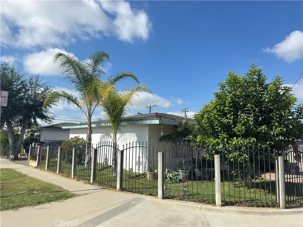 a view of a house with a iron fence