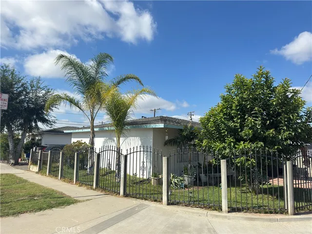 a view of a house with a iron fence
