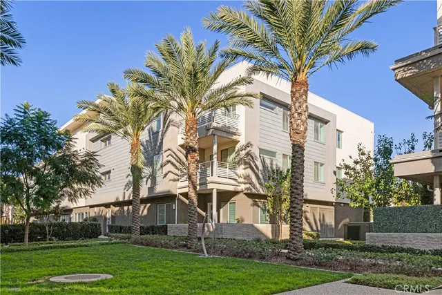 a view of a white house with a big yard and a large tree