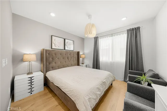 a spacious bedroom with a bed and a couch