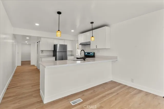 a view of kitchen with wooden floor