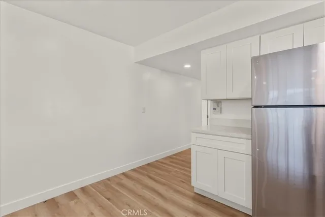 a room with a refrigerator and a stove