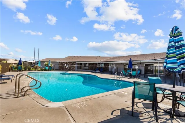 a view of a house with a big yard and large trees