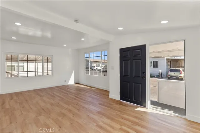 a view of an empty room with a kitchen
