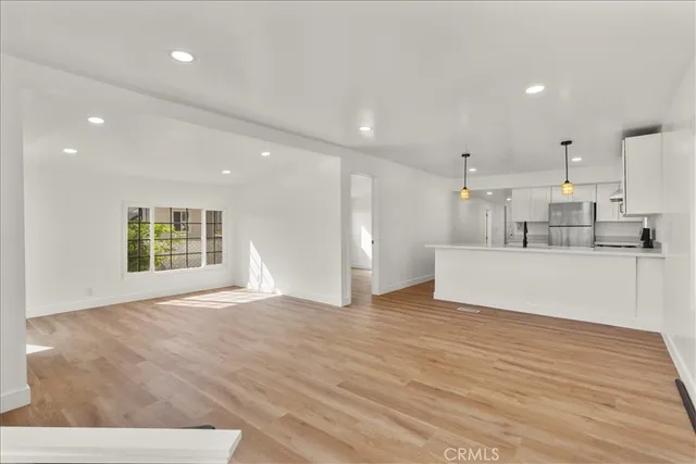 a view of kitchen with stainless steel appliances cabinets