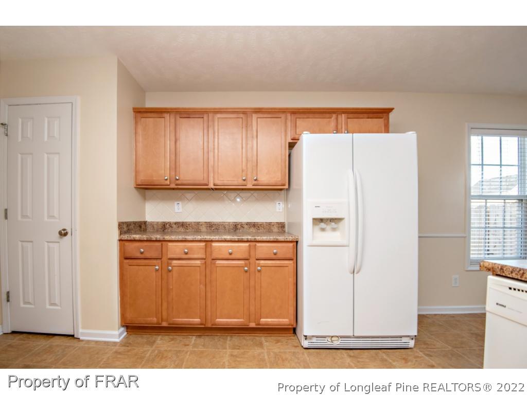 1957 Yellowbrick Road Fayetteville, NC 28314 - Photo 12 of 27 a white refrigerator freezer sitting inside of a kitchen