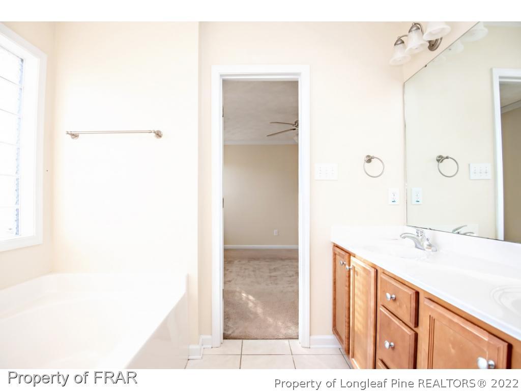 1957 Yellowbrick Road Fayetteville, NC 28314 - Photo 15 of 27 a bathroom with a sink and a mirror