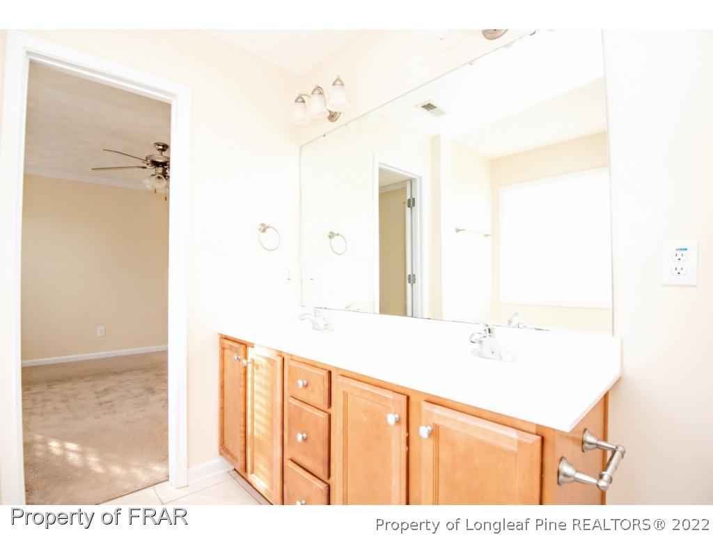 1957 Yellowbrick Road Fayetteville, NC 28314 - Photo 16 of 27 a bathroom with a sink and a mirror