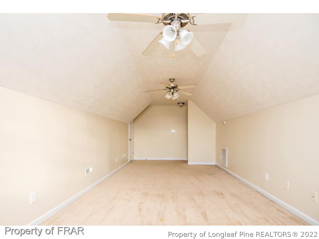 1957 Yellowbrick Road Fayetteville, NC 28314 - Photo 22 of 27 an empty room with a ceiling fan and a window