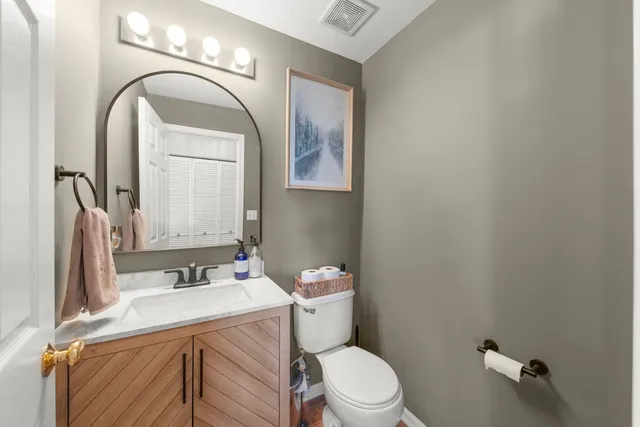 a bathroom with a sink a toilet and mirror