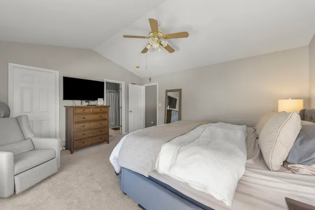 a bedroom with a bed and a television