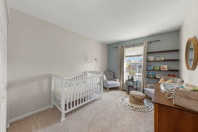 a bedroom with furniture and a book shelf