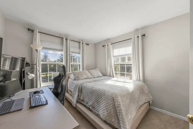 a bed sitting in a bedroom next to a window