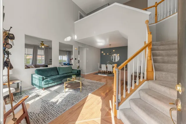 a living room with furniture and a dining table