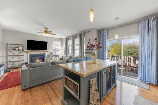 a living room with furniture a flat screen tv and a floor to ceiling window