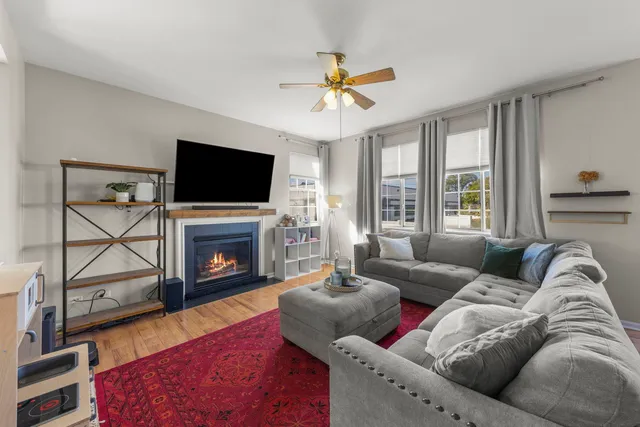 a living room with furniture a flat screen tv and a fireplace