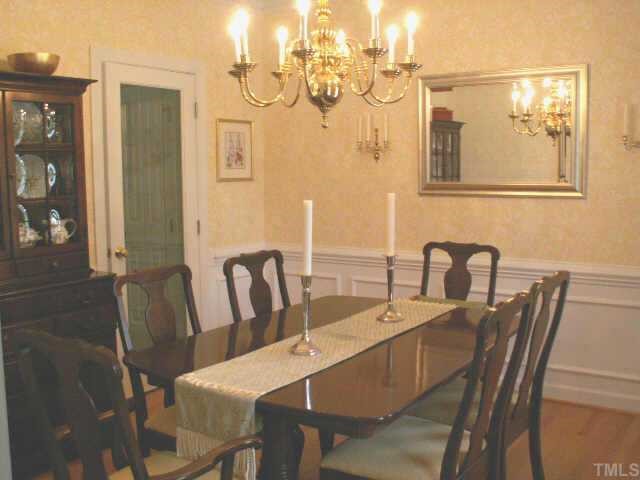 7705 Wilderness Road Raleigh, NC 27613 - Photo 5 of 10 a dining room with furniture and wooden floor