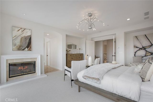 a bedroom with a large bed and a fireplace