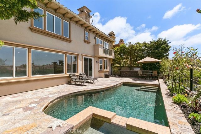 a view of a house with swimming pool and furniture