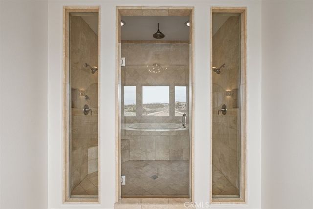 a bathroom with a glass shower door and a mirror