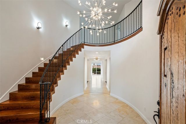 a view of staircase with lots of frames on wall and wooden floor