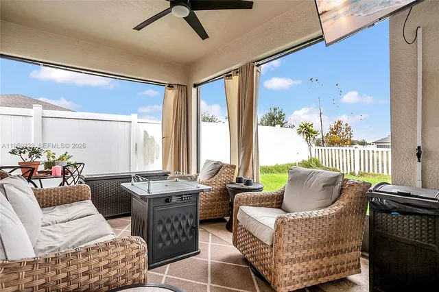 a living room with furniture and a large window