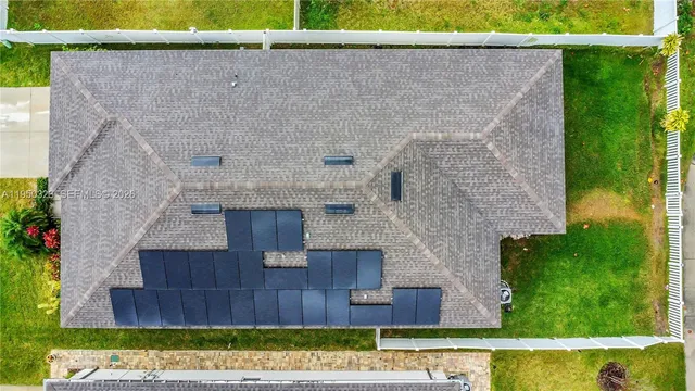 an aerial view of residential houses with swimming pool and ocean view