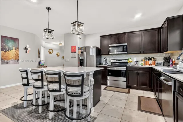 a kitchen with granite countertop a sink appliances and cabinets