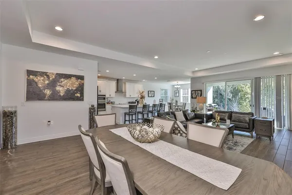 a living room with lots of furniture and view of kitchen