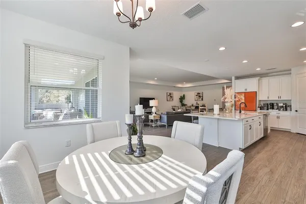 a living room with kitchen island furniture and a chandelier