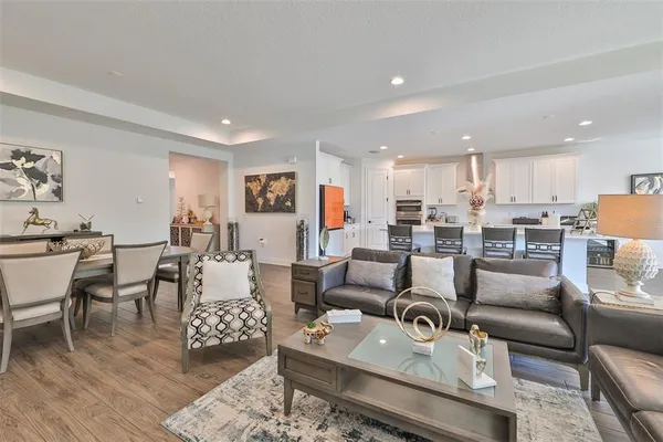 a living room with furniture kitchen view and a dining table