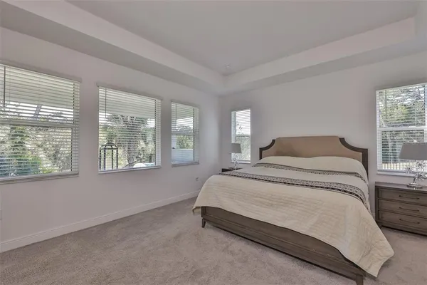a bedroom with a bed lamp and window
