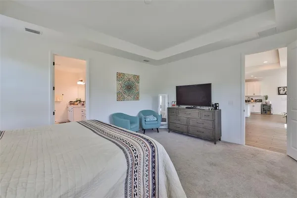 a bedroom with bed and a flat screen tv