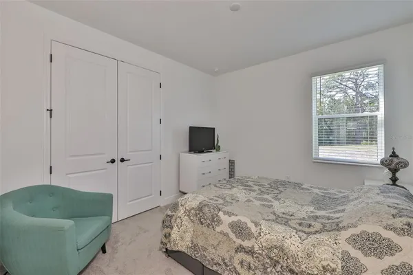 a bedroom with a bed and a couch