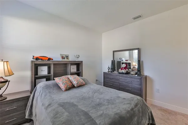 a bed room with furniture and a mirror