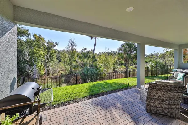 a backyard of a house with wooden floor and outdoor seating