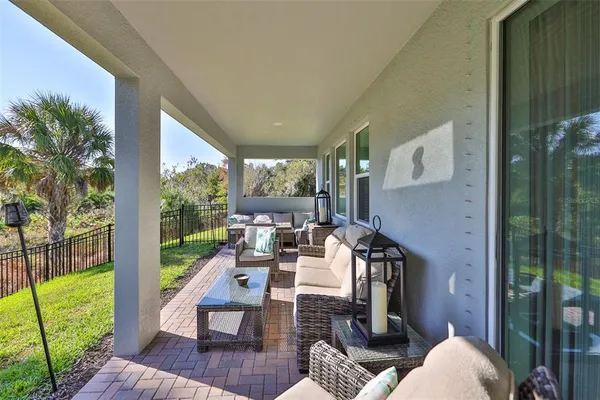 a view of deck with furniture and garden