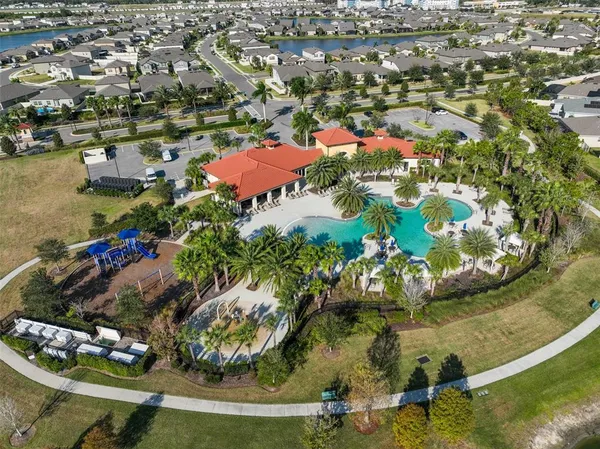 an aerial view of a house with a yard and a fountain