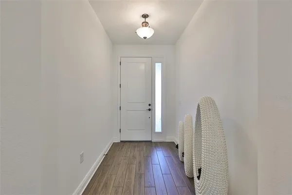 a view of a room with wooden floor and ceiling fan