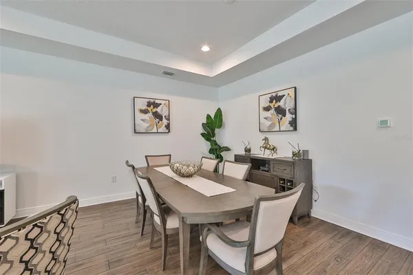 a view of a dining room with furniture and wooden floor