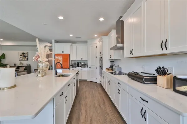 a kitchen with kitchen island granite countertop a sink a stove and refrigerator