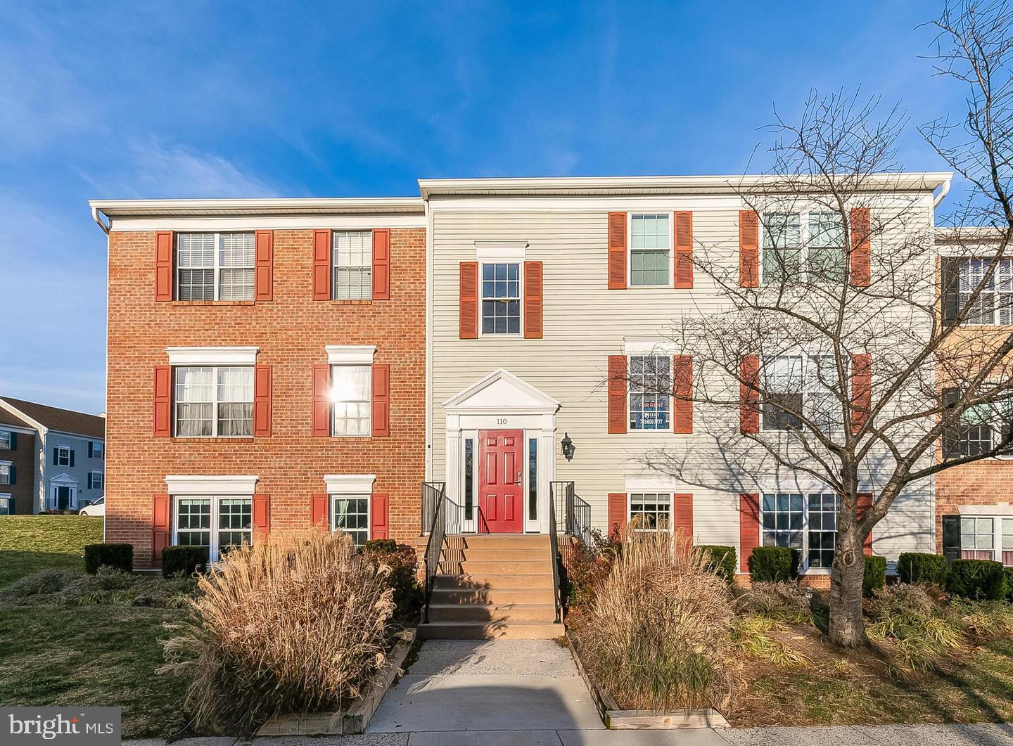110 Prosperity Avenue Southeast, Unit D Leesburg, VA 20175 - Photo 1 of 25 a front view of a building with a yard
